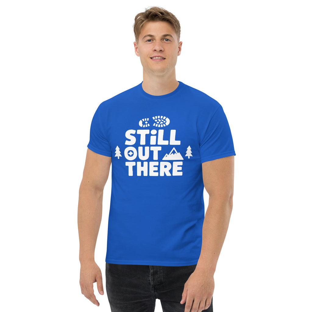 Royal blue hiking T-shirt with white “STILL OUT THERE” logo on the chest