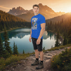 Royal blue hiking T-shirt on model with skull-and-forest front graphic and text