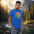 Royal blue T-shirt with a circular multicolor trail badge graphic on the chest.
