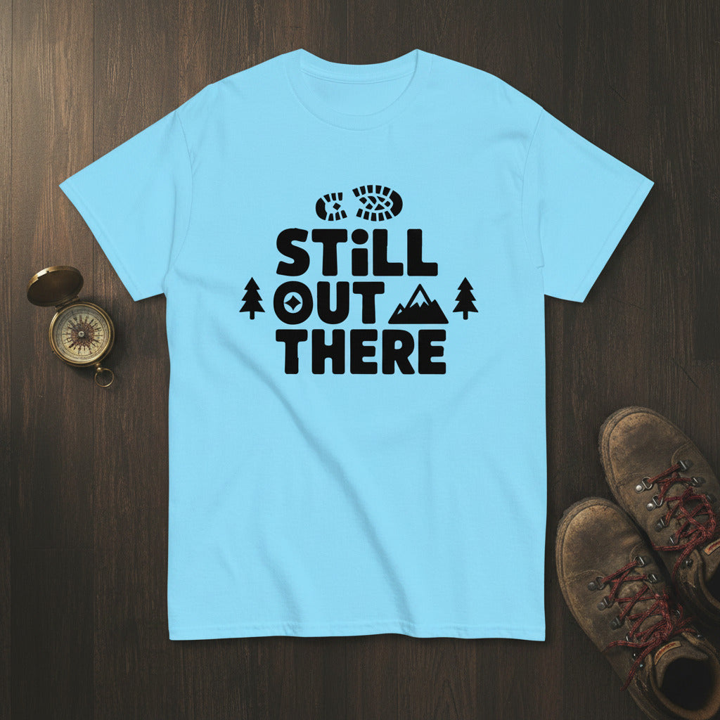Sky blue crewneck hiking T-shirt with black “STILL OUT THERE” logo and tree graphic