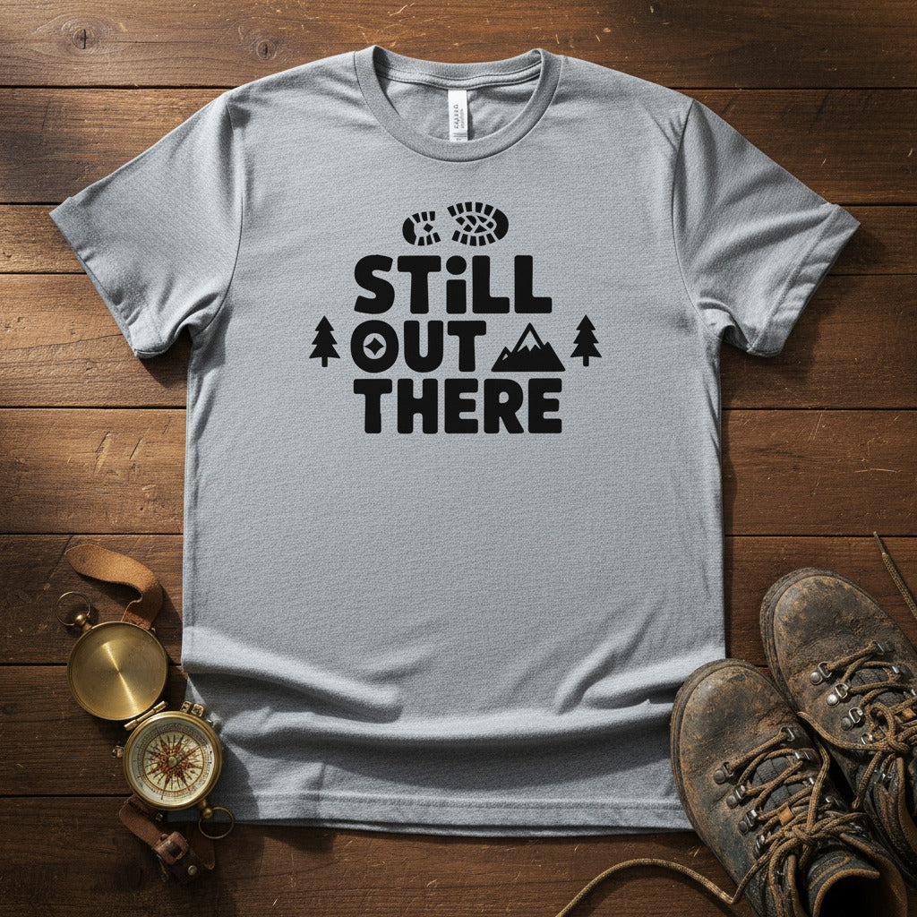 Grey crewneck hiking T-shirt with black “STILL OUT THERE” logo and tree graphic