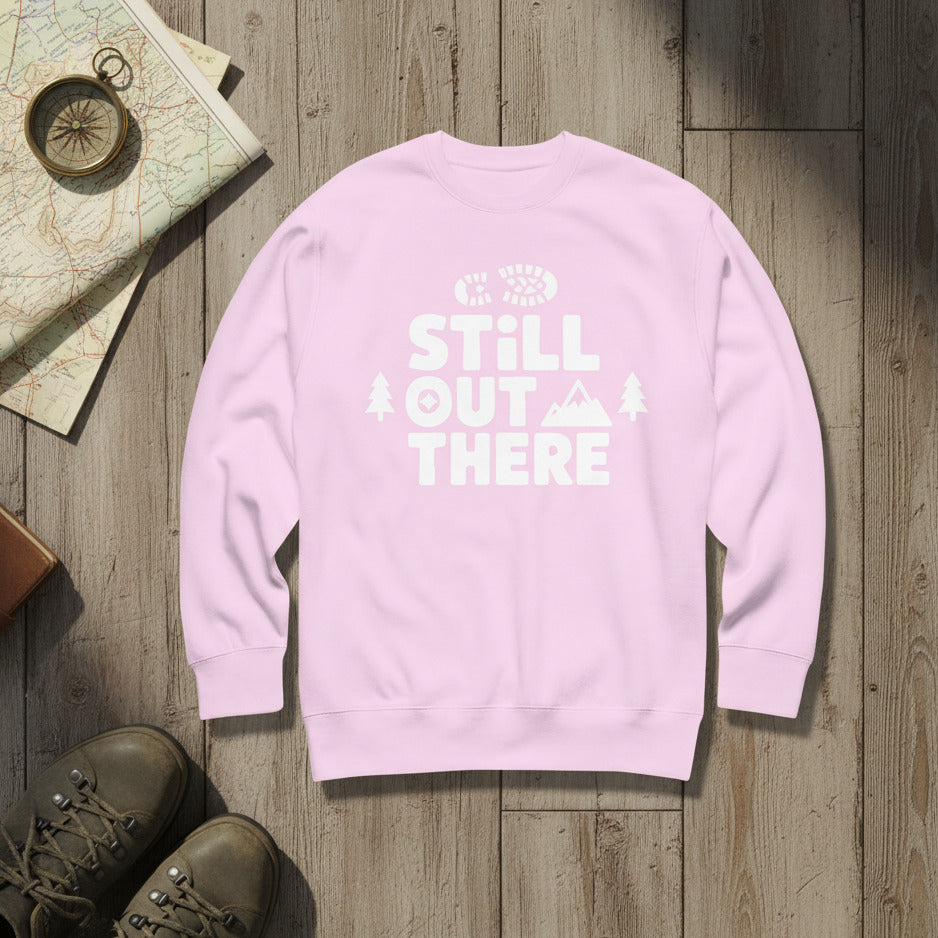 Hiking premium sweatshirt, lavender with white "STILL OUT THERE" logo and tree graphic