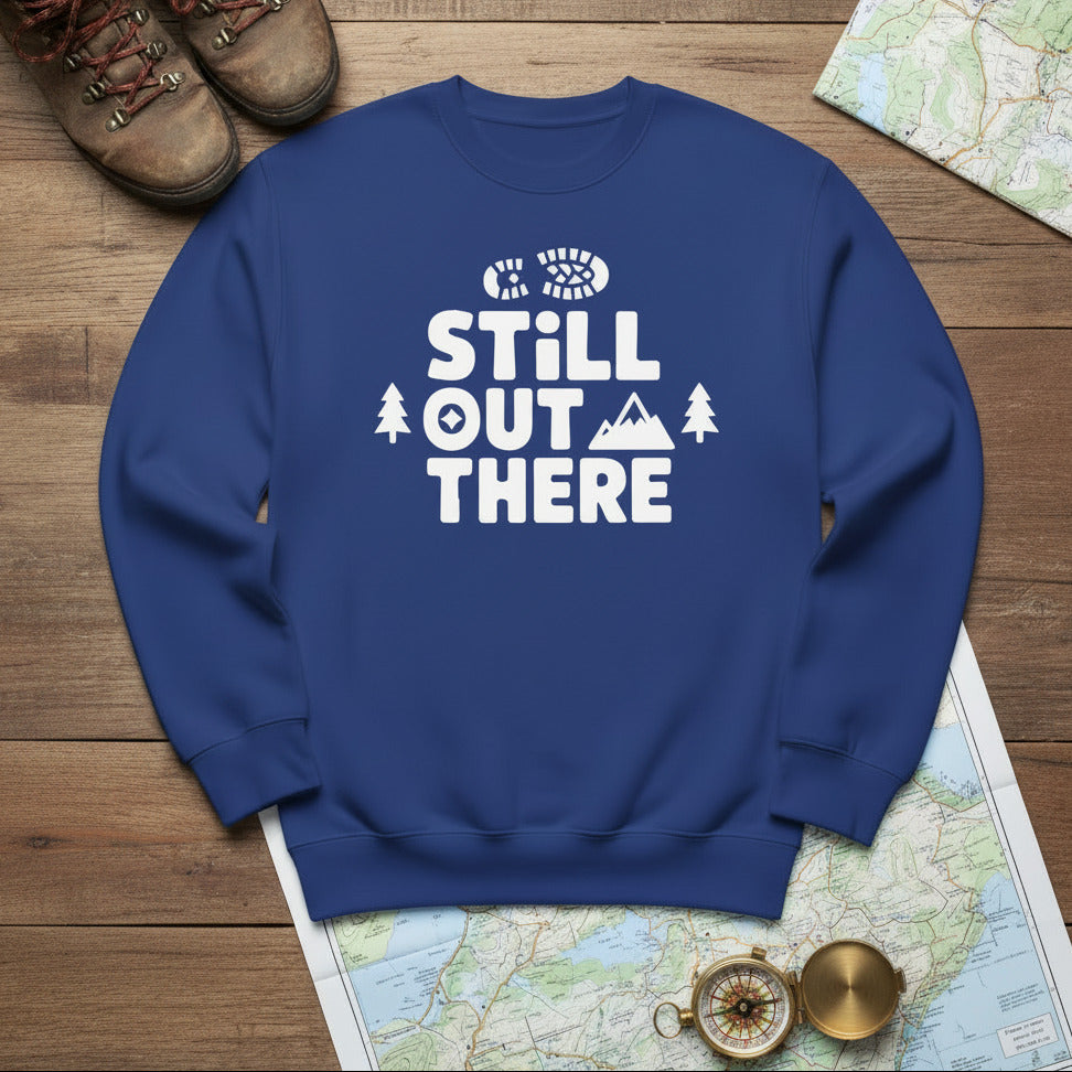 Hiking premium sweatshirt, blue with white "STILL OUT THERE" logo and tree graphic