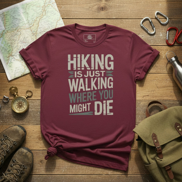 Oxblood maroon hiking T-shirt with graphic text: HIKING IS JUST WALKING WHERE YOU MIGHT DIE