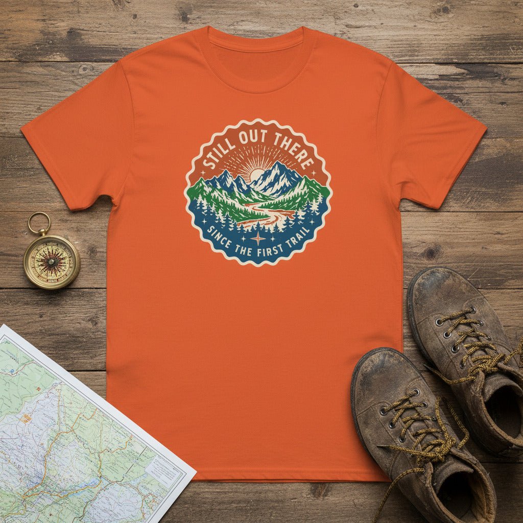 Orange hiking t-shirt with round vintage trail badge graphic on the chest